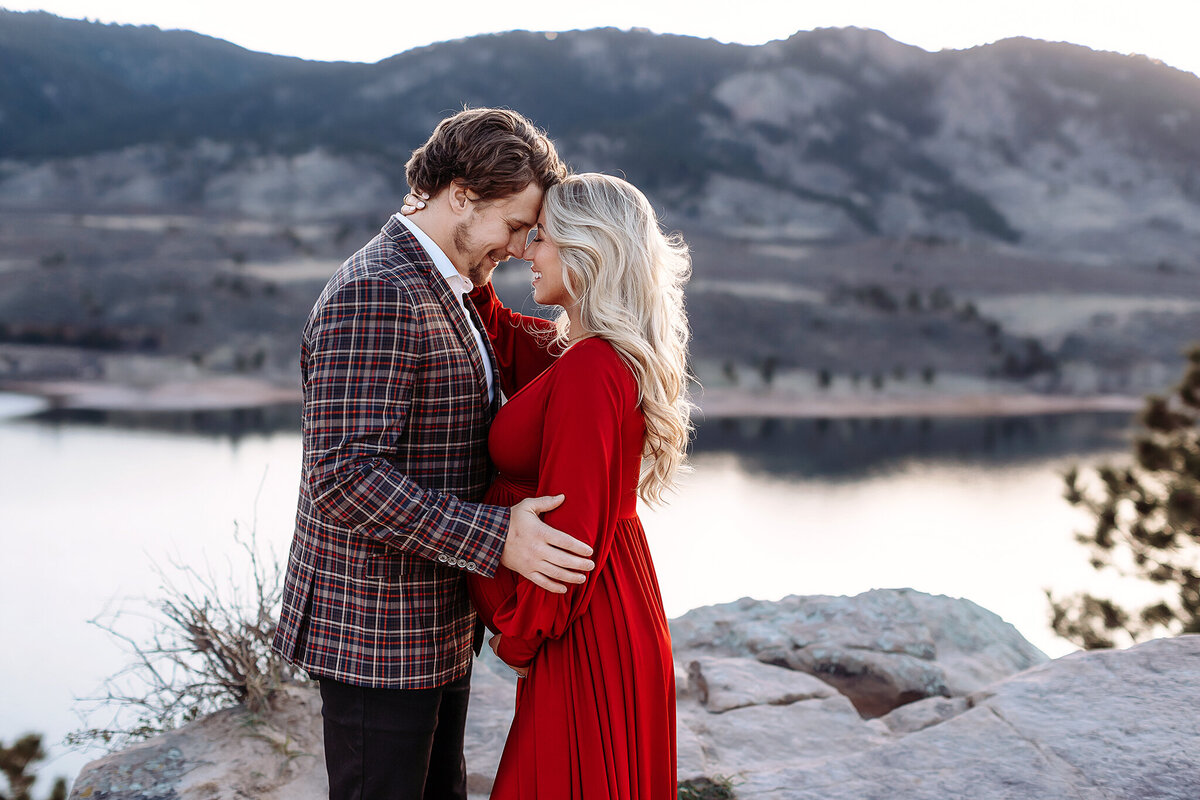 couple posed lovingly for their boulder maternity photos
