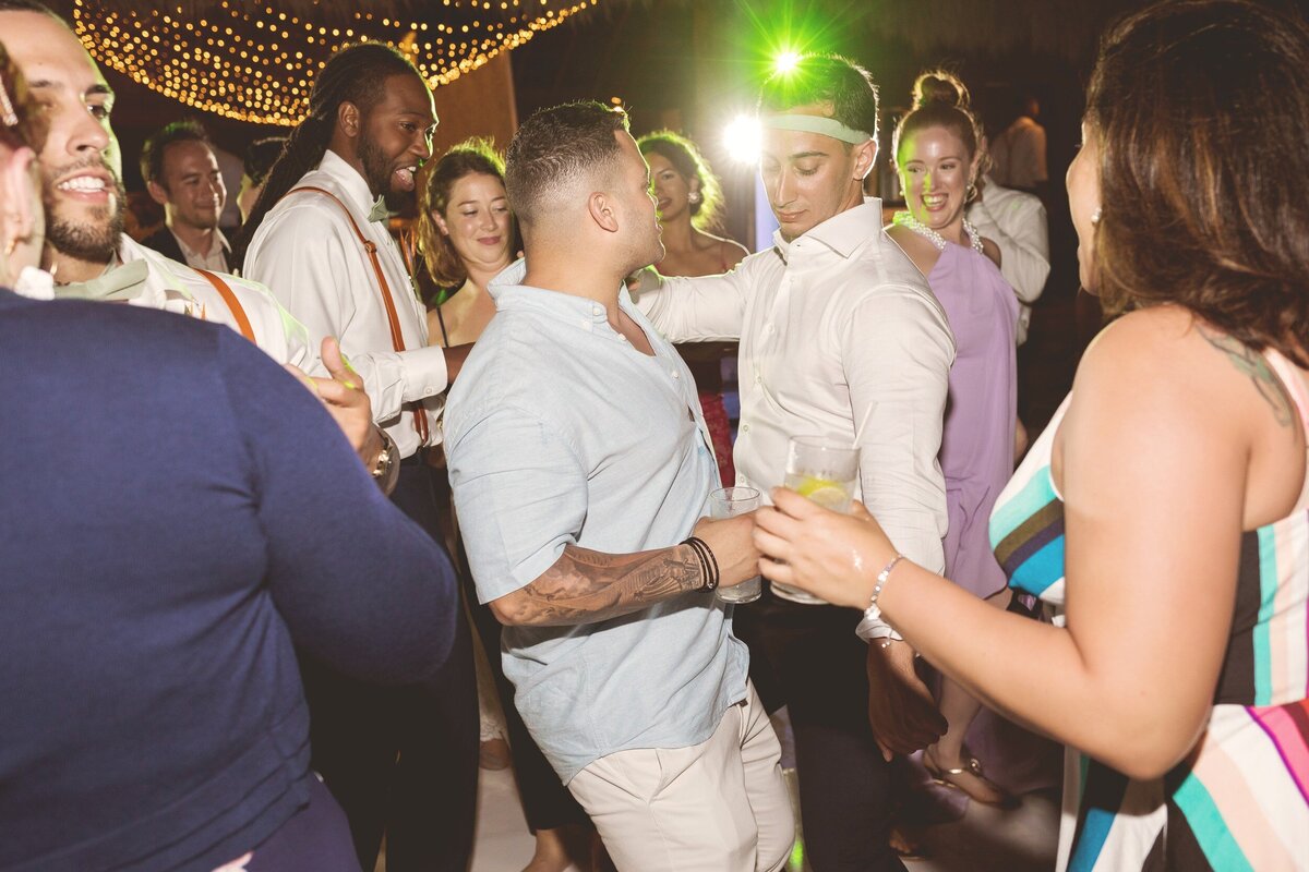 Groom dancing with guests at wedding in Cancun