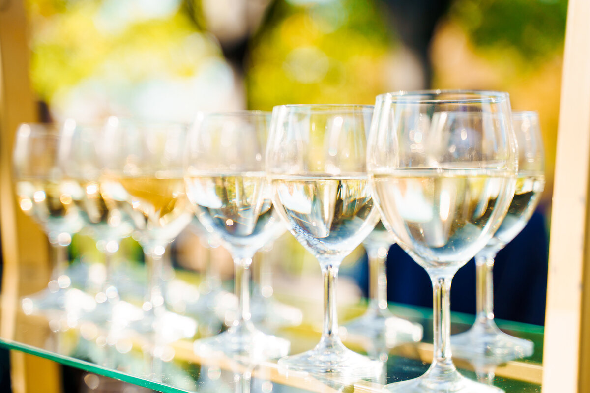 Clear, glistening glasses of white wine during cocktail hour at a wedding at Pinnacle Golf Course in Grove City, Ohio.