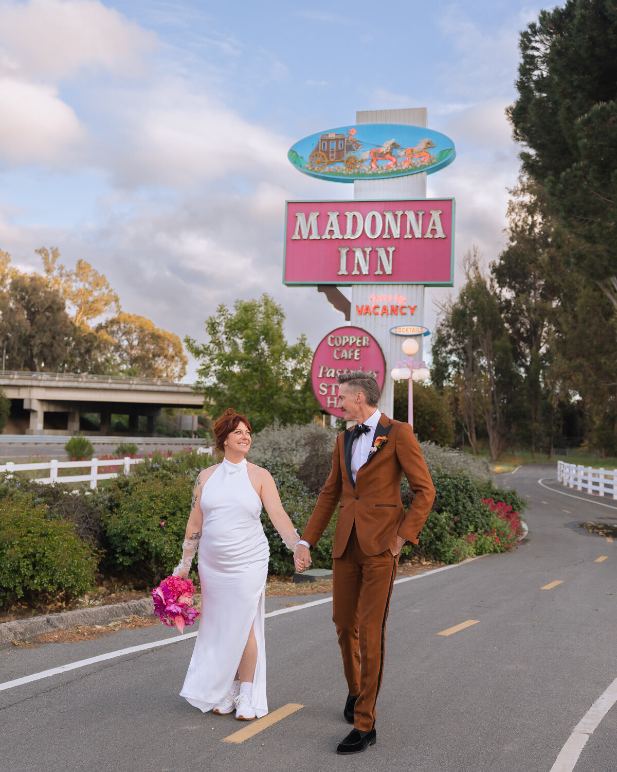 Madonna Inn wedding couples photos with colorful flower bouquet during sunset photos in San Luis Obispo