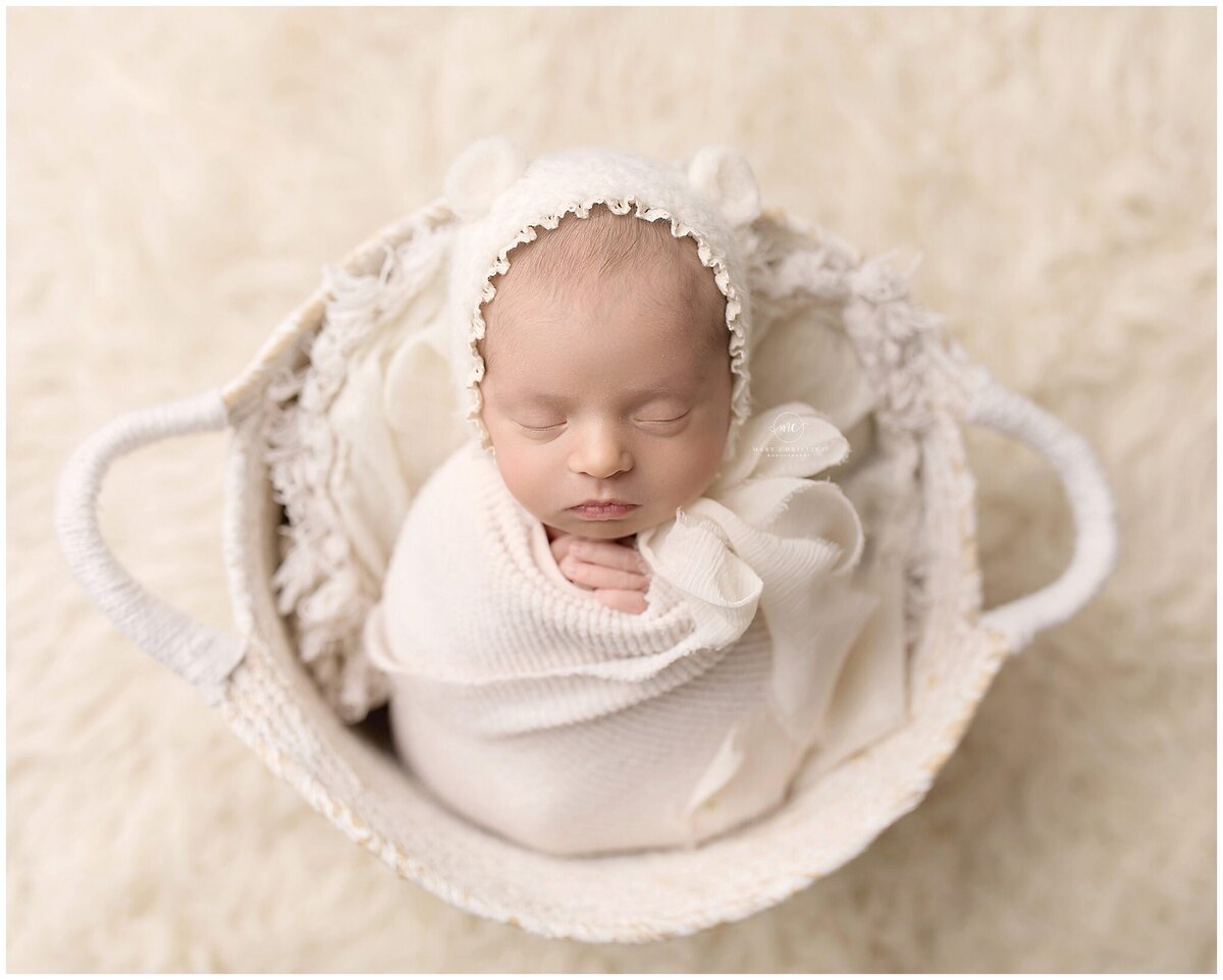 A newborn in a bear bonnet by Medina Photographer Mary Christine