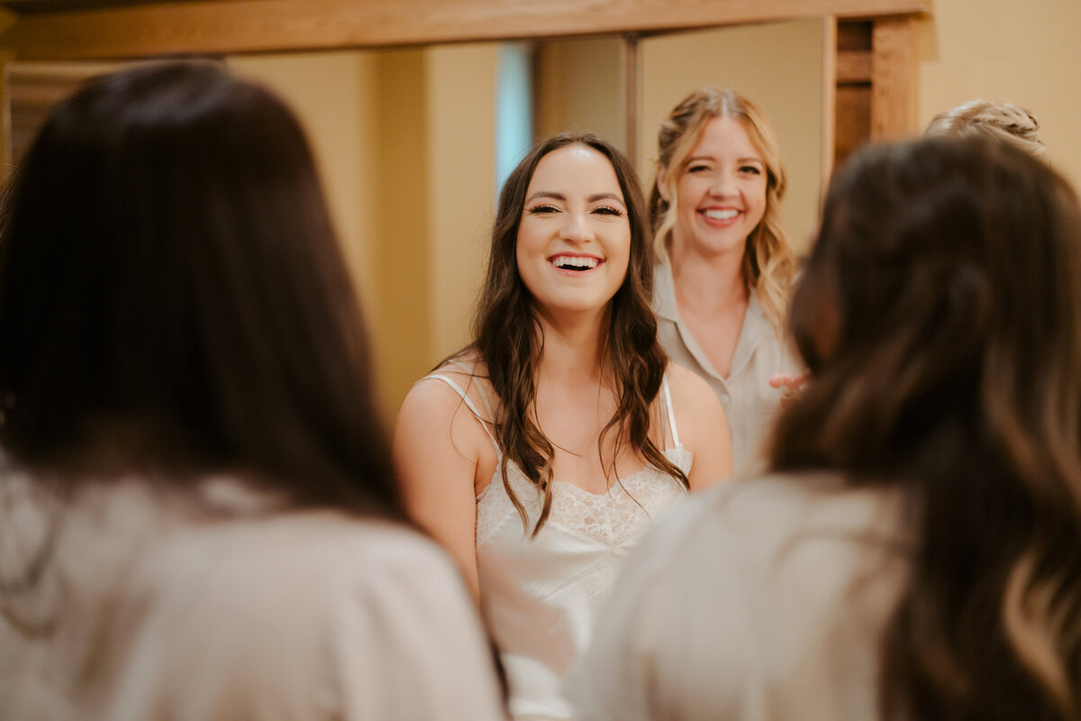 bride smiling at her bridesmaids