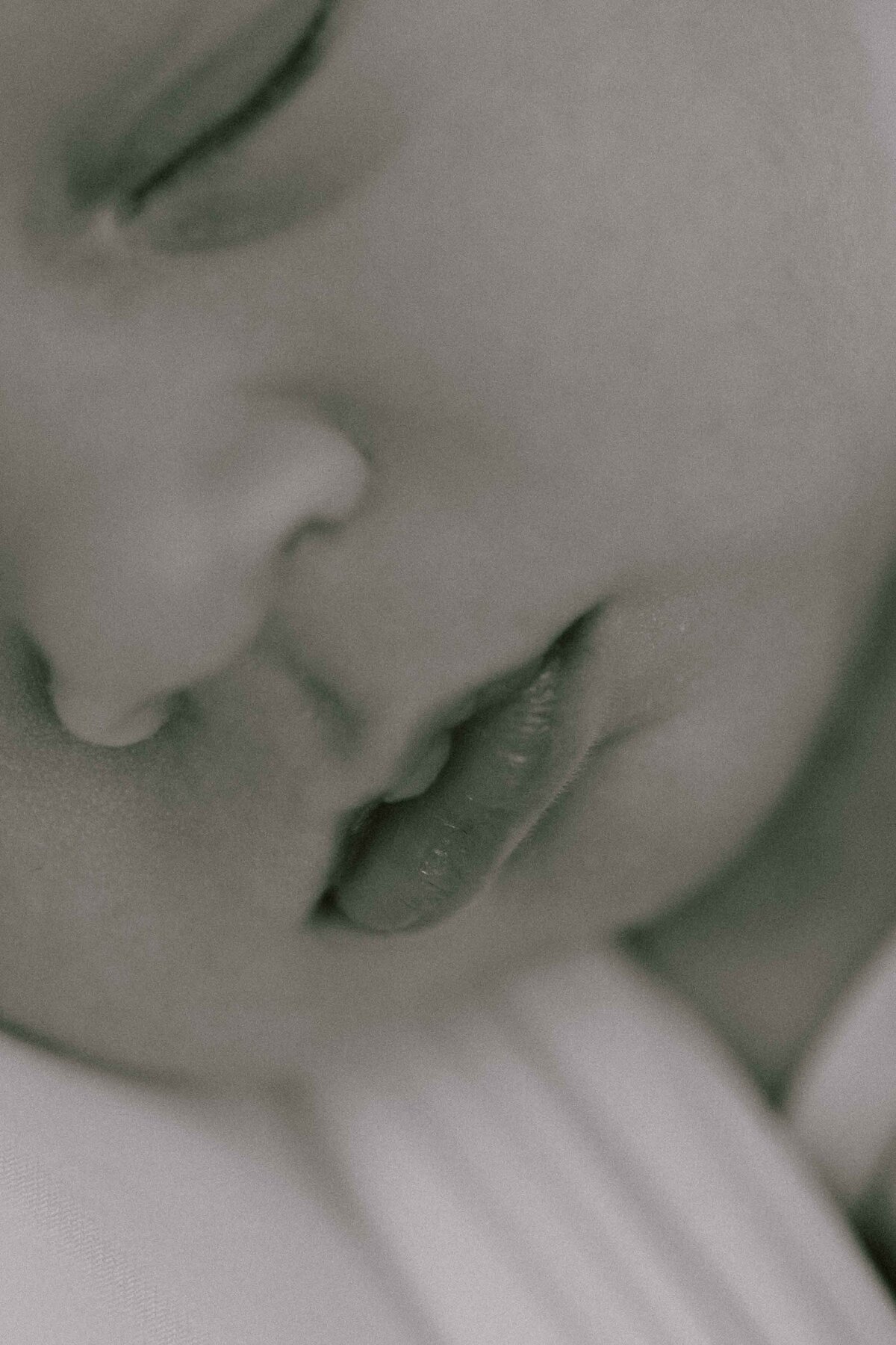 black and white close-up photo of newborn baby's lips, chin, and nose