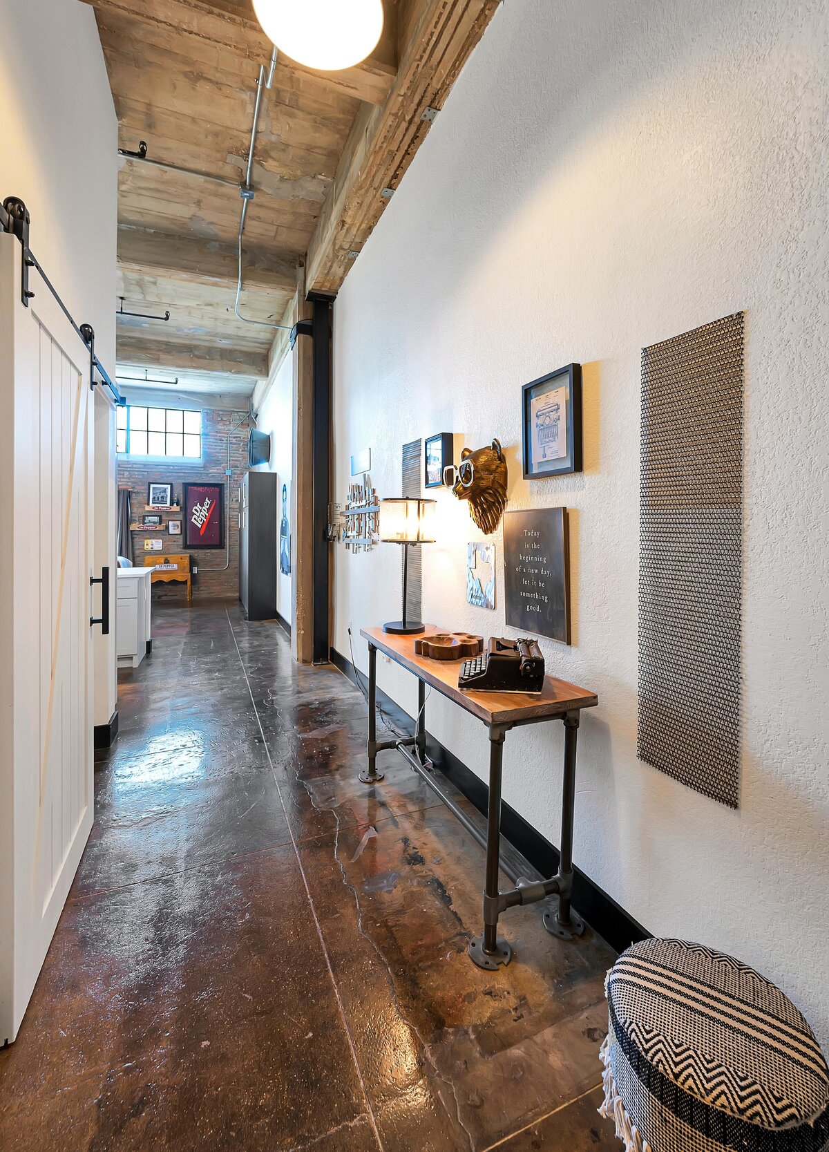 This is the entry space with entry table at this one-bedroom, one-bathroom vintage industrial condo with Smart TV, free Wi-Fi, and washer/dryer located in downtown Waco, TX.