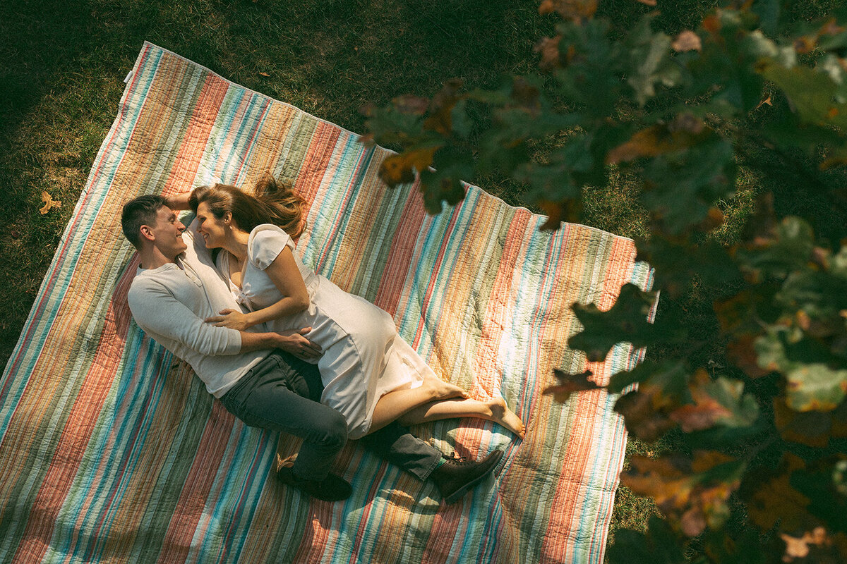 Aerial view of pregnant mother lying in a backyard during an outdoor maternity session in Northern Virginia