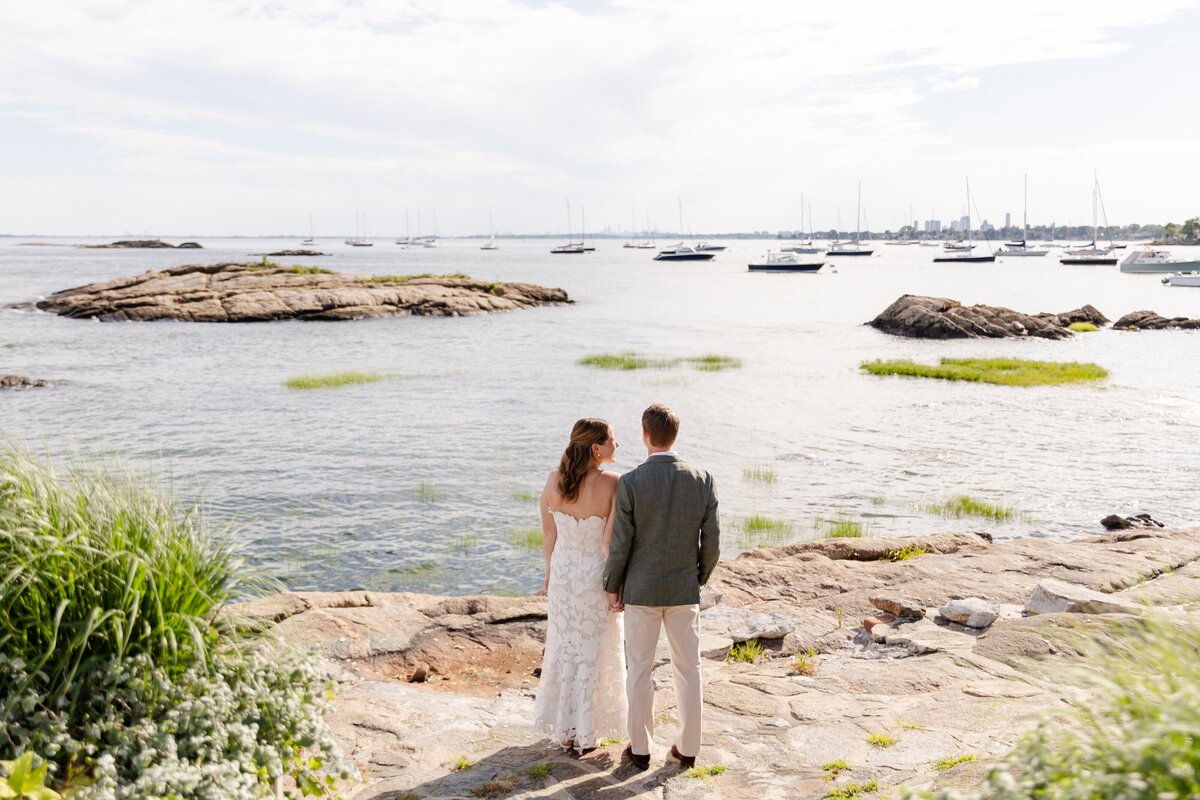 couple look out over the water at American Yacht Club in Rye, NY 