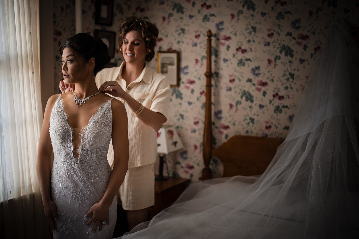 A bride gets ready in the brick house at shelburne farms at a destination wedding in Vermont