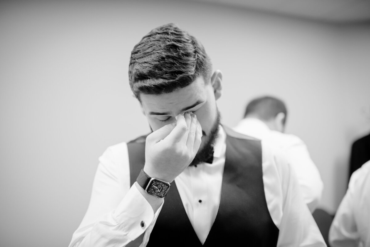 Witness the heartfelt moment as an emotional groom at Anais Events Center in Bellaire, Texas, expresses tears of joy on this unforgettable day.
