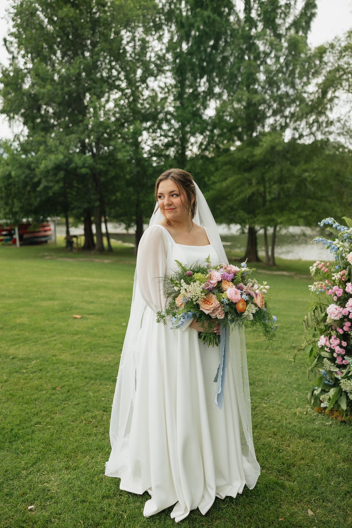 Bride with colorful bouquet designed by Abby Grace Florals at Dahlonega GA wedding