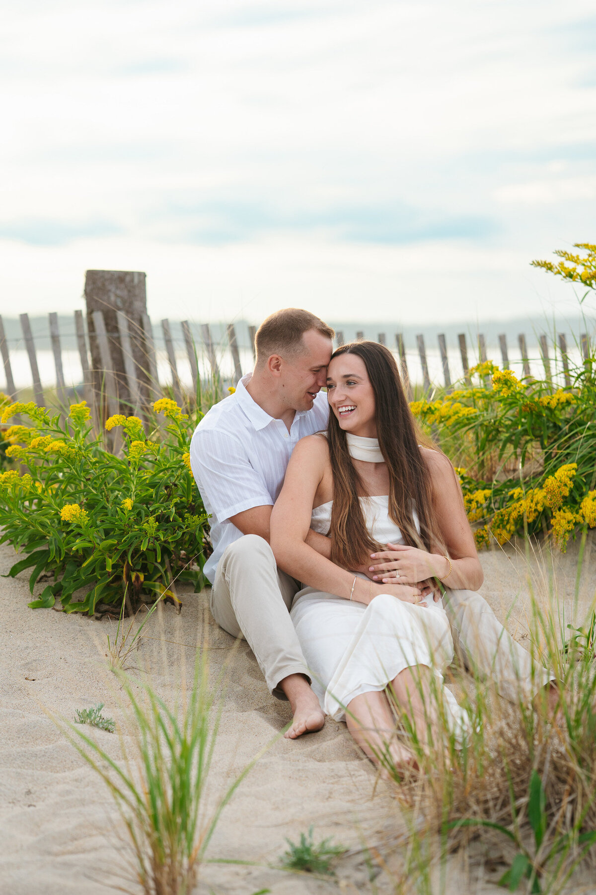 Romantic coastal engagement session in New England overlooking the shoreline.