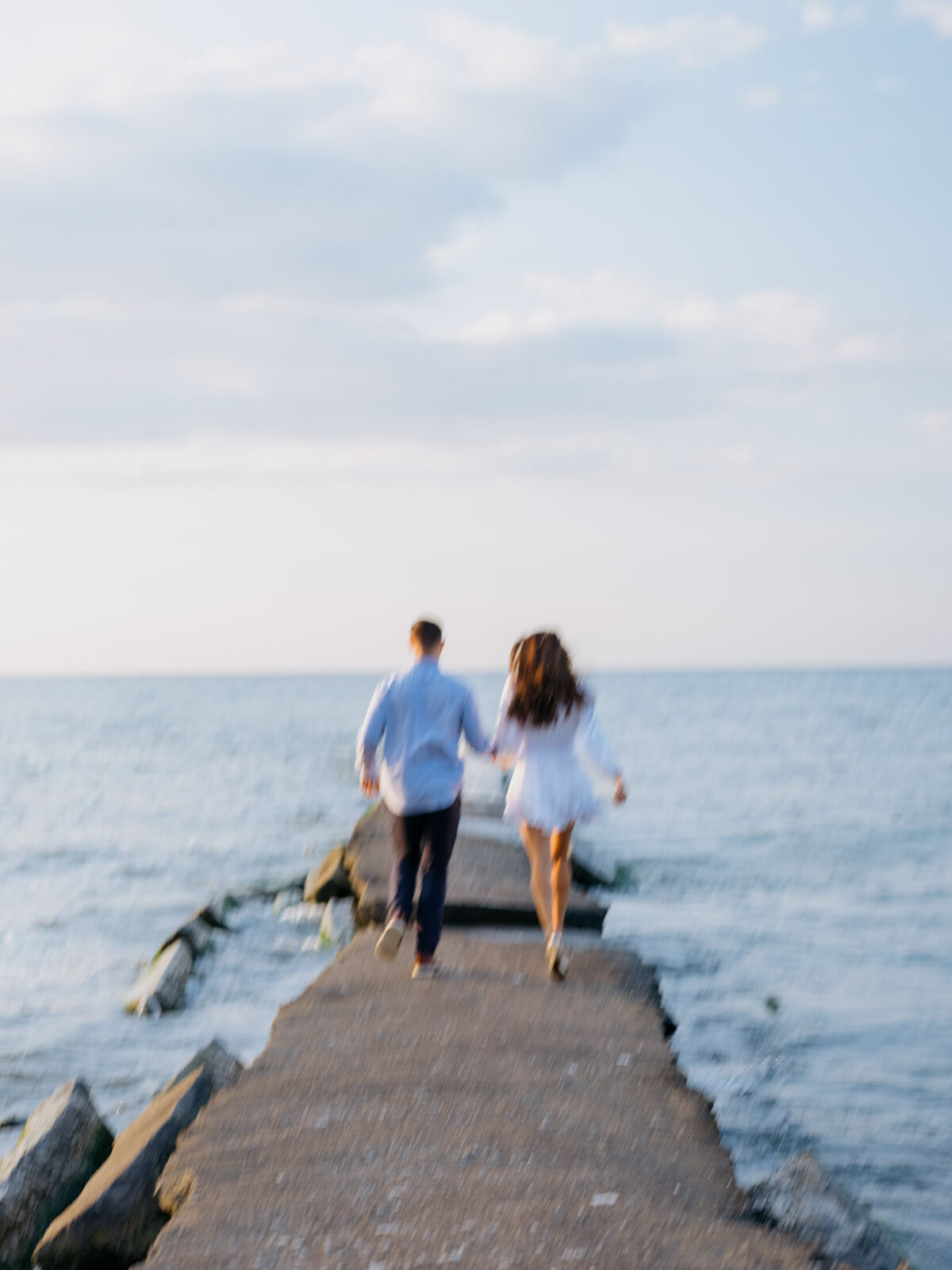 Outdoor engagement session with scenic lake views on a Cleveland beach.