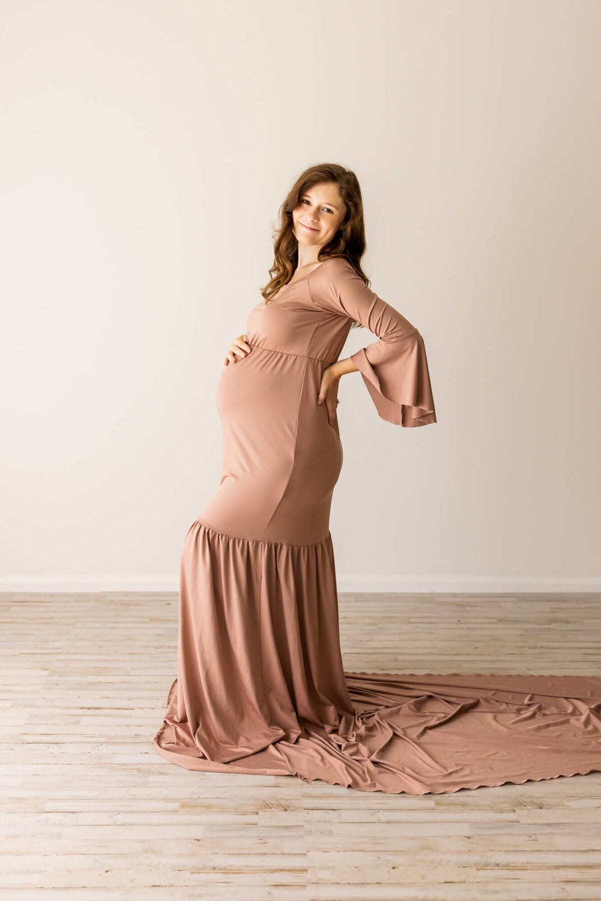 Mom to be in a taupe maternity dress