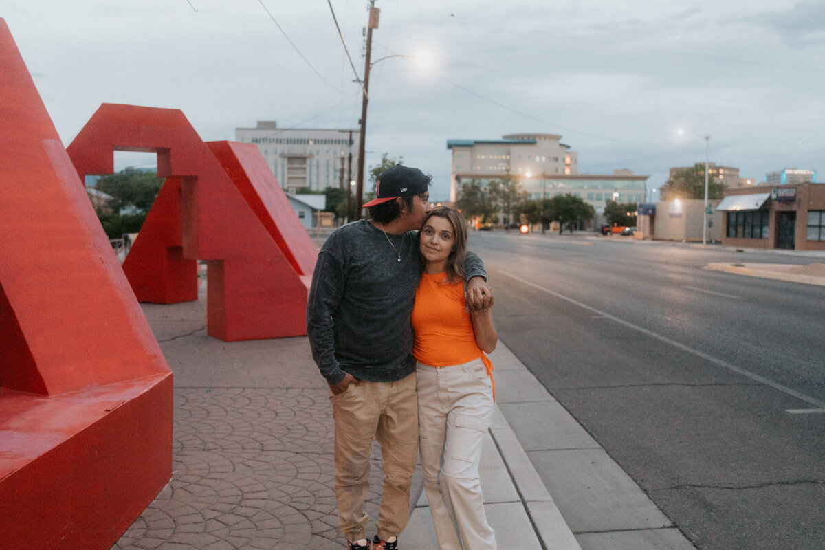 couple leaning against wall