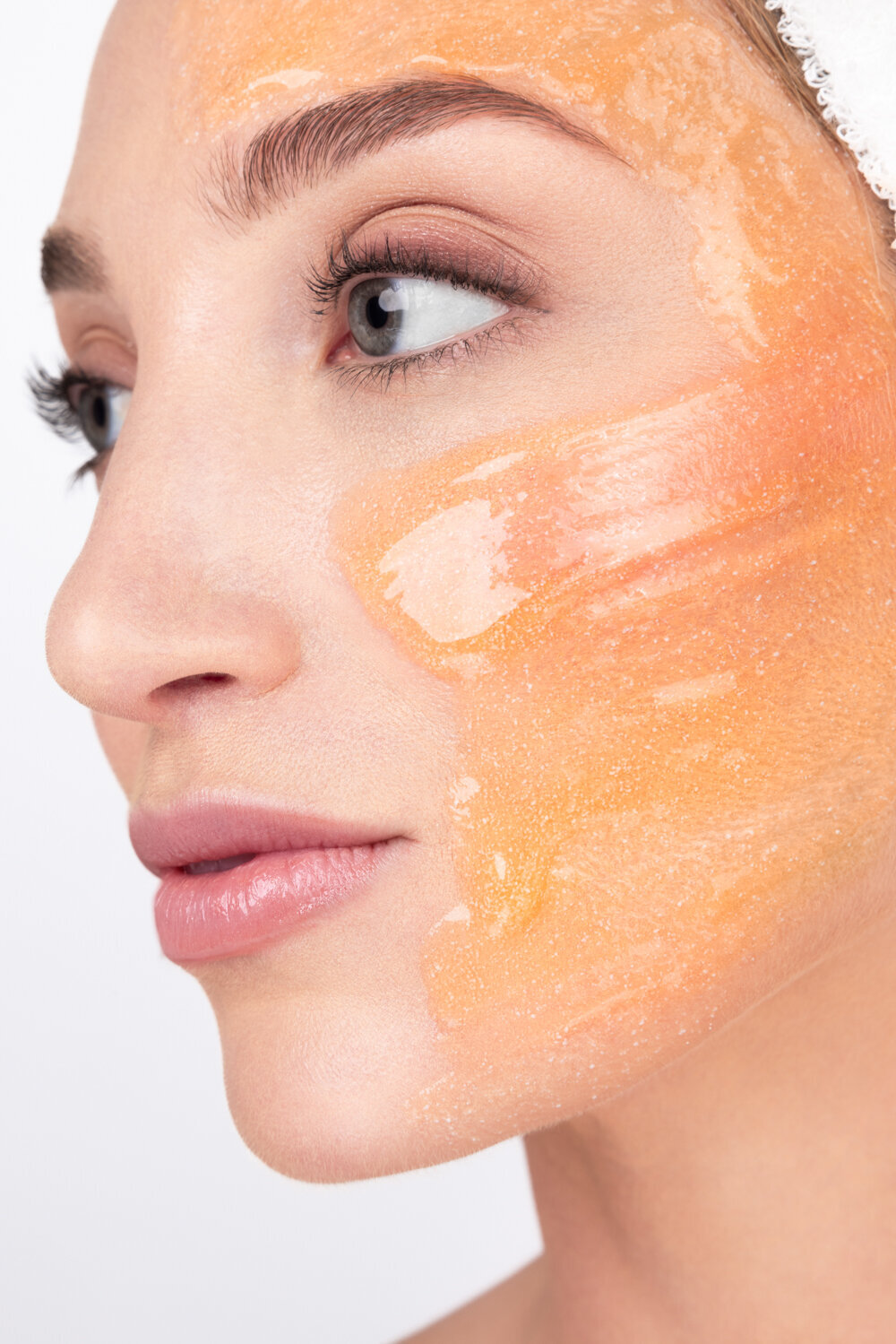 Beauty photography close-up of model wearing orange peeling mask