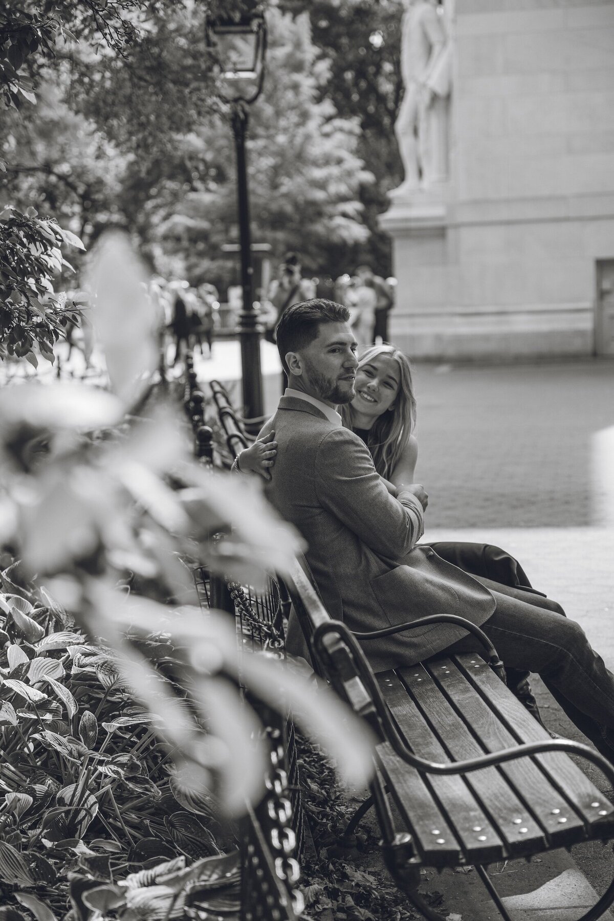 Couple cuddling on a park bench, soaking in the moment.