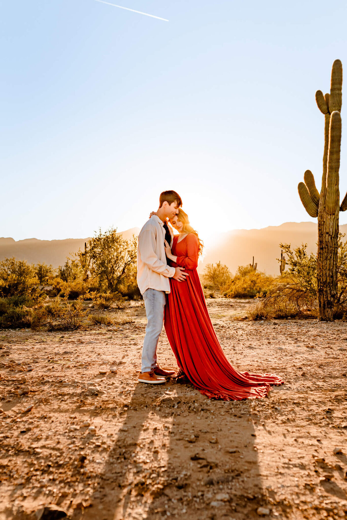 couple hugging during their maternity photography session in AZ