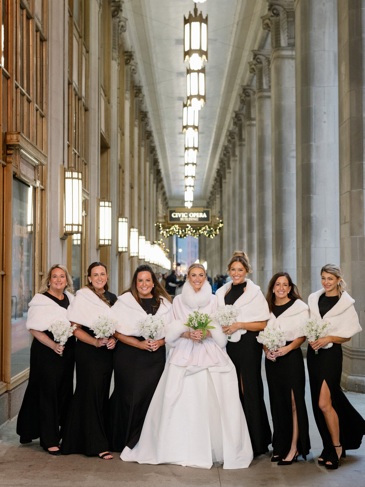 Bride and bridesmaids posing for a photo in the Palmer House Chicago. 