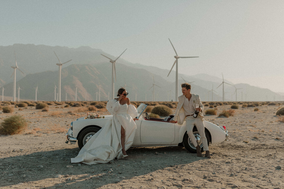 couple in front of car in palm springs