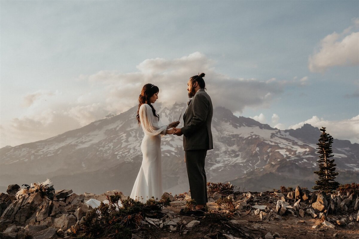 Bride & groom sharing their vows during their elopement ceremony with Mount Rainier as the backdrop!