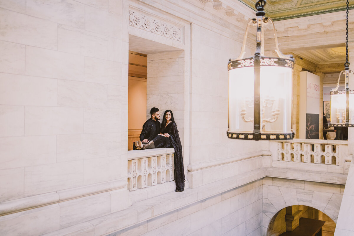 Engaged Bride and groom sitting by the window inside the new york public library