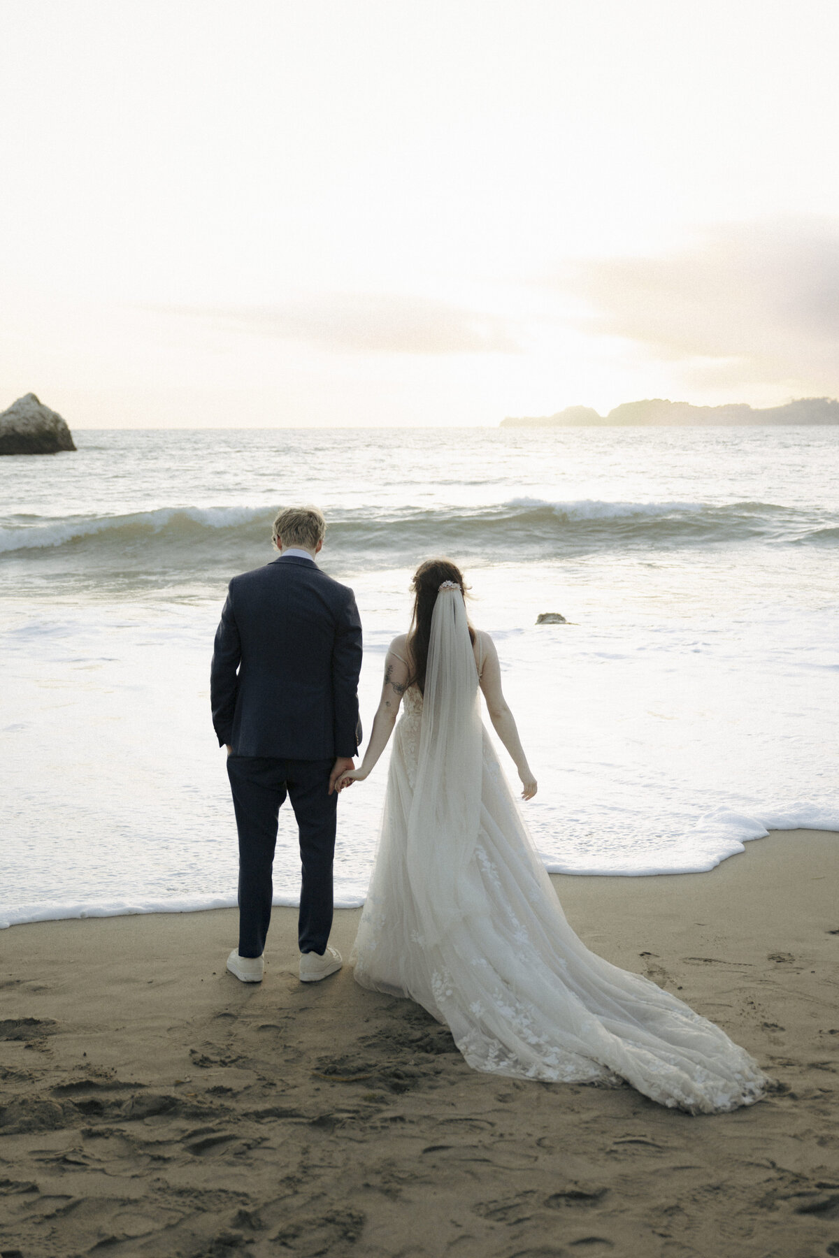 Bride and Groom at Marshall's Beach in San Francisco, California at sunset
