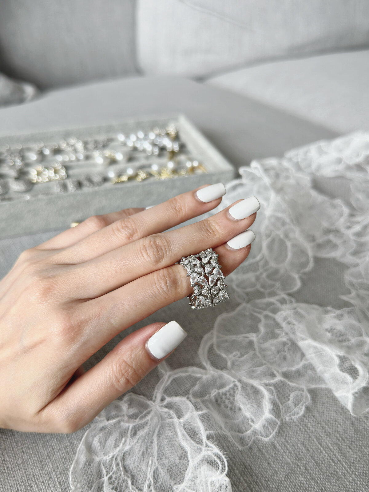 Bride accessorized with classic pearl and crystal drop earrings
