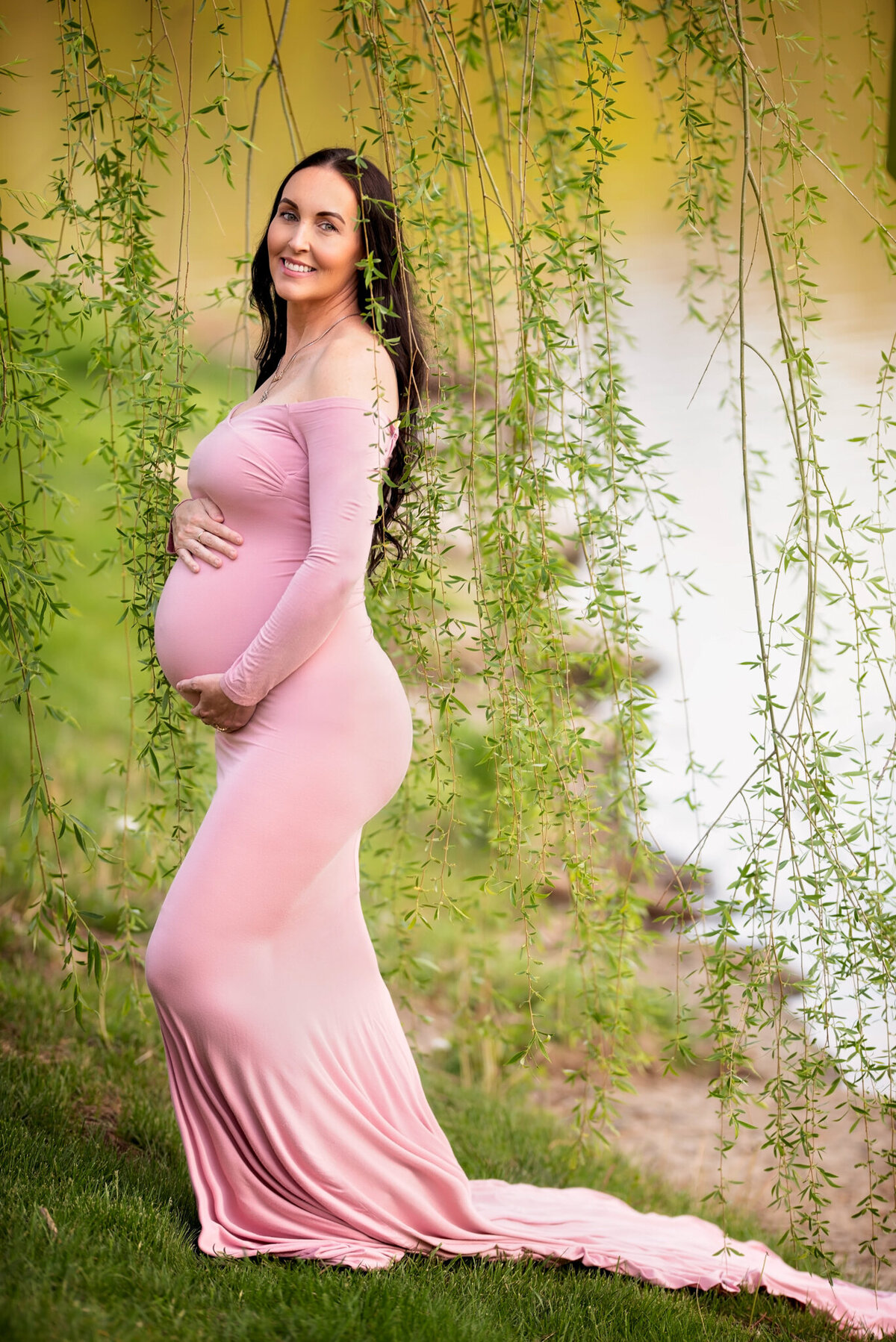 Beautiful outdoor maternity portrait with a glowing mother-to-be in a pink gown, captured in Overland Park, Kansas. Ideal for families looking for natural maternity photography near Kansas City