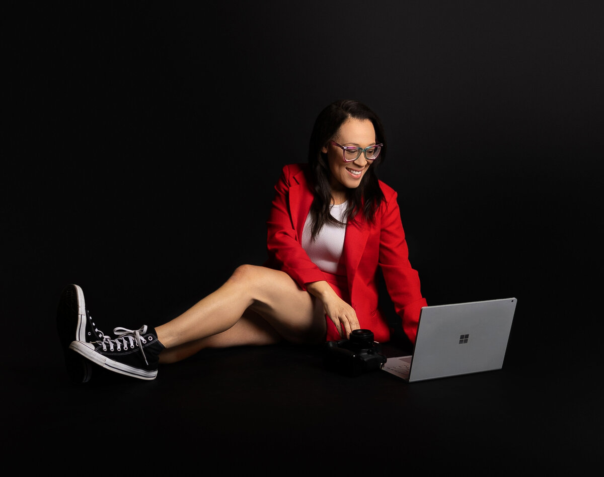 Women wearing red typing on laptop during photoshoot with Franklin, Tennessee photographer 