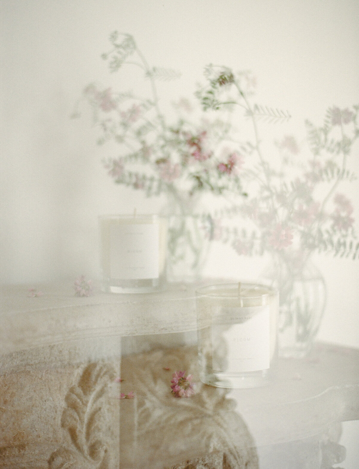 artistic film branding photography for candle company, candle on ornate mantle with wildflowers