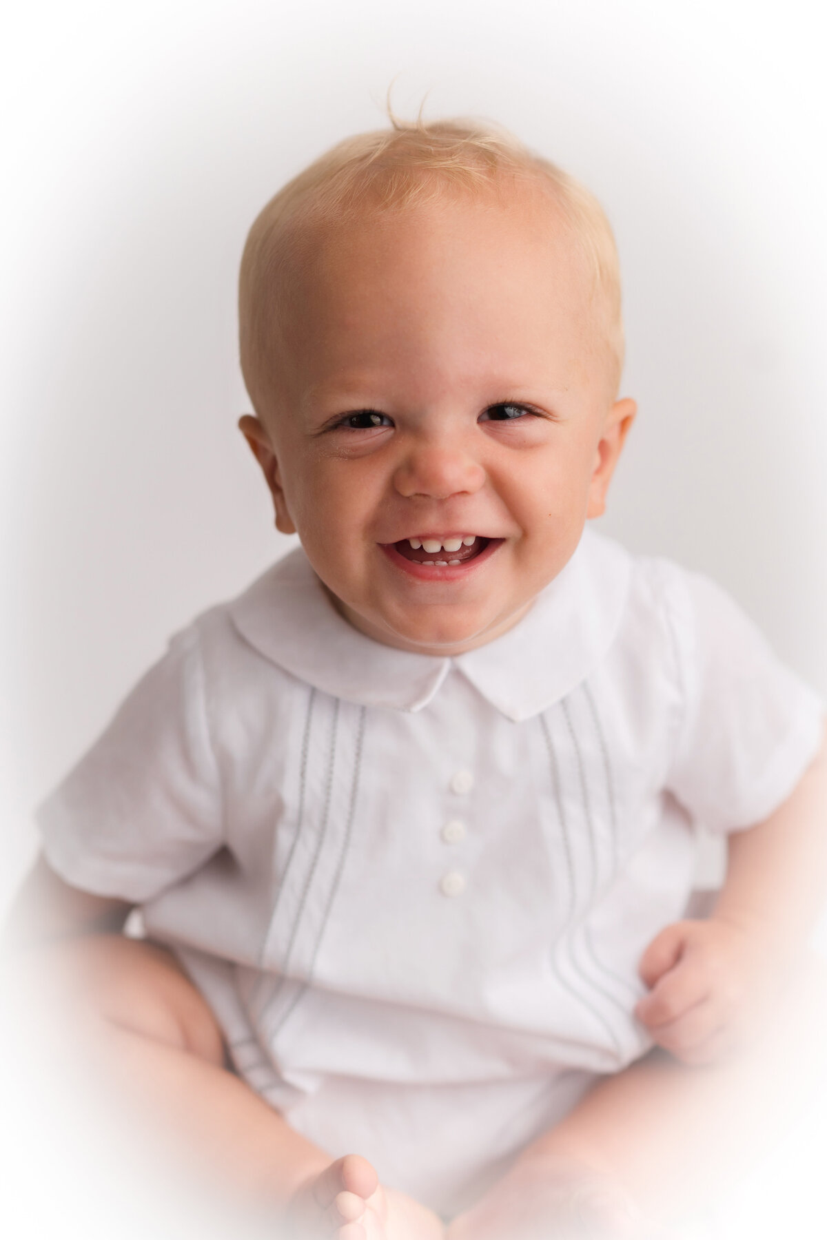 Baby boy laughs at the camera during Heirloom Portrait Session in Charleston, South Carolina.