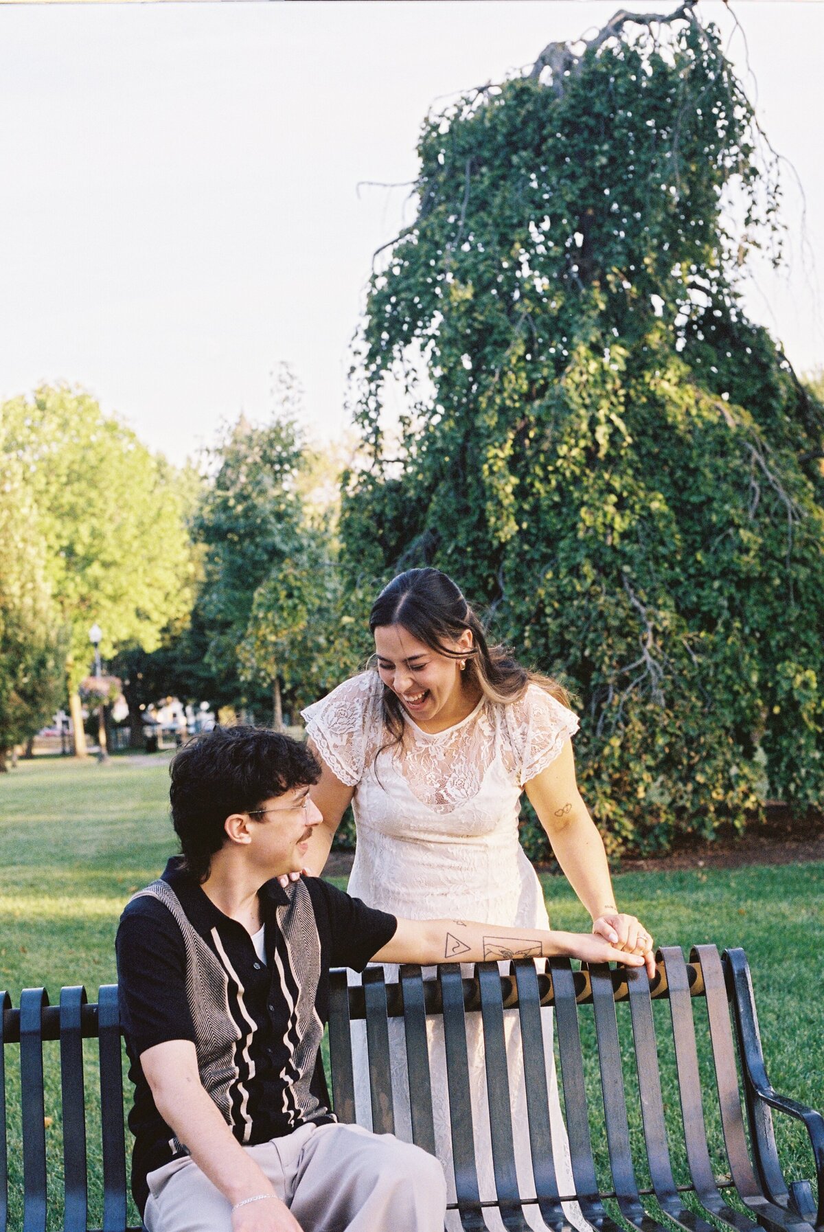 couple laughing on park bench
