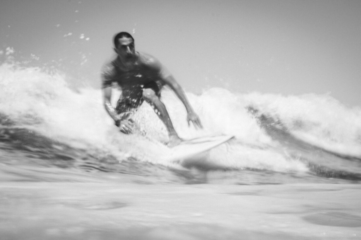 Black and white photo of man surfing