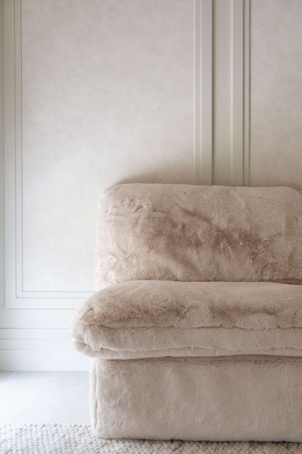 Plush tan couch in a light and airy children's playroom.