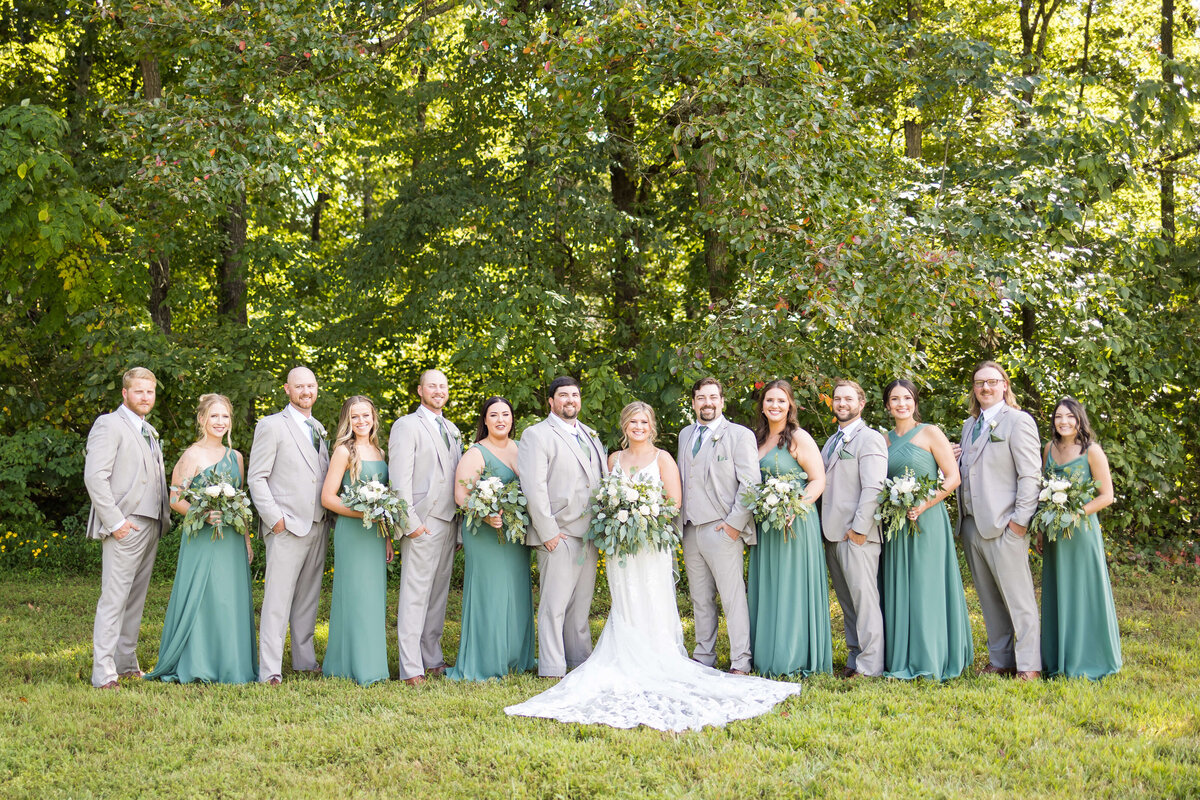 Bride with bridesmaids in green dresses at  The Barn at White Oaks, Murray, Kentucky