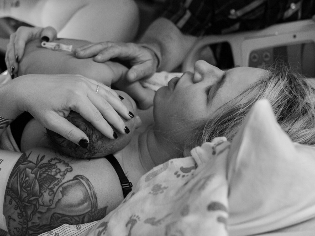 a mother is holding her newborn for the first time after giving birth at Overlake Childbirth Center in Bellevue, WA captured by Seattle Birth Photographer, Becky Langseth.