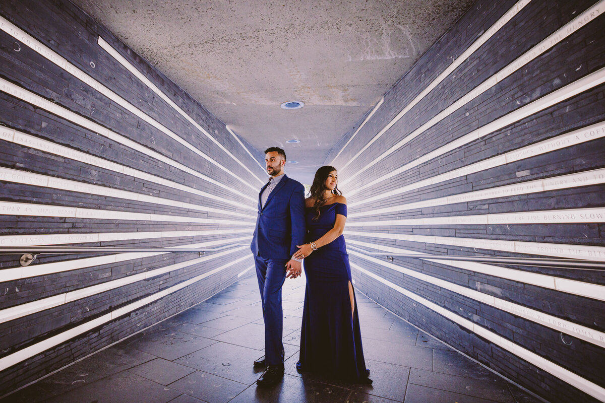 Engaged couple standing in a stripe light hallway in battery park in nyc