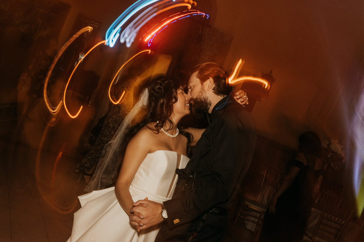 A newlywed couple dancing at their wedding reception 
