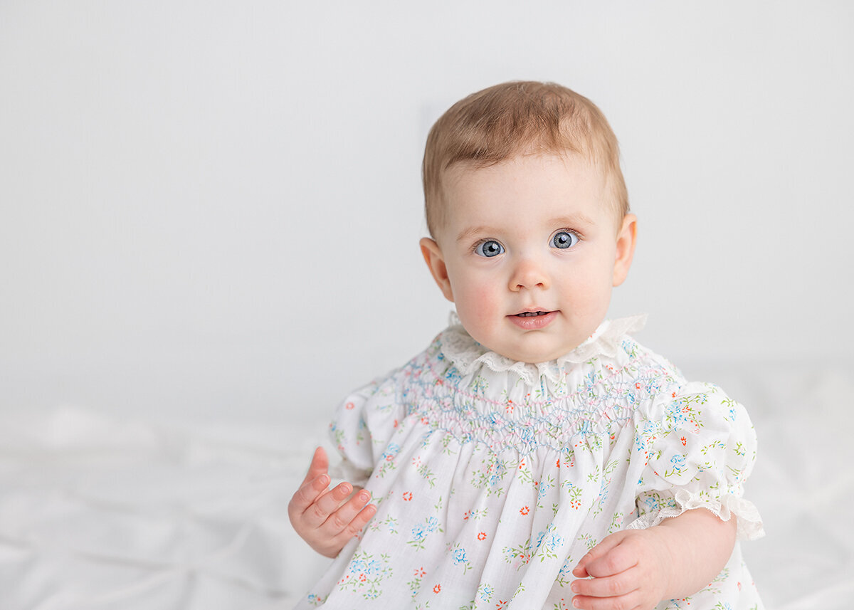 9 month baby girl photographed in studio in  vintage grandmillenial outfit