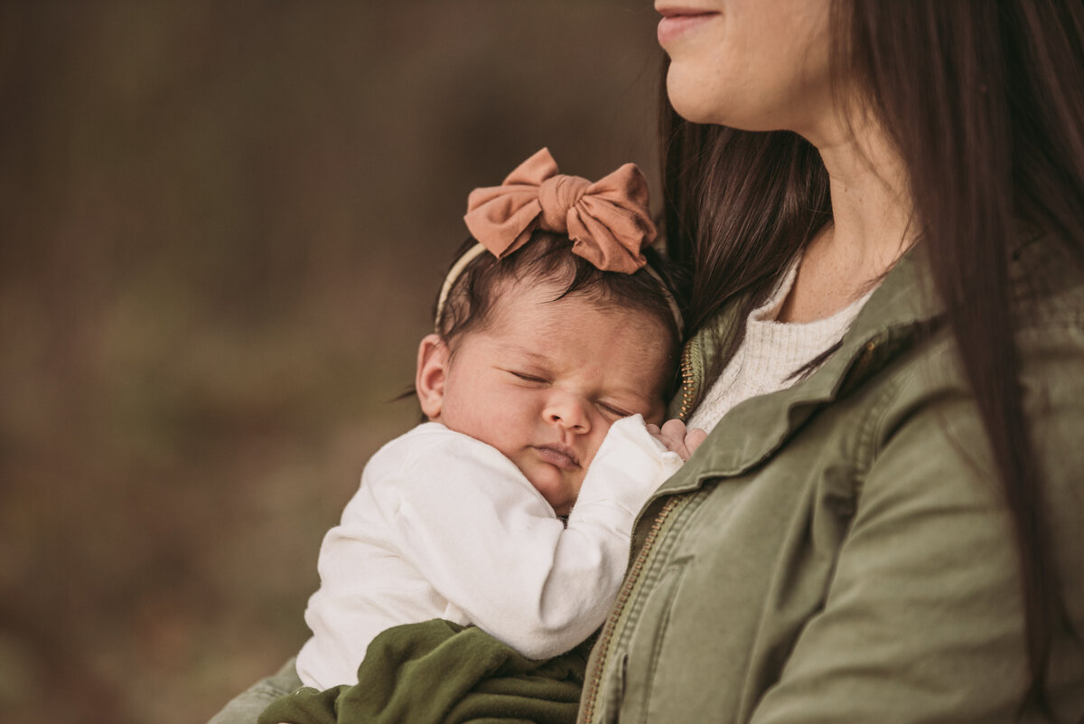 mom snuggling newborn baby