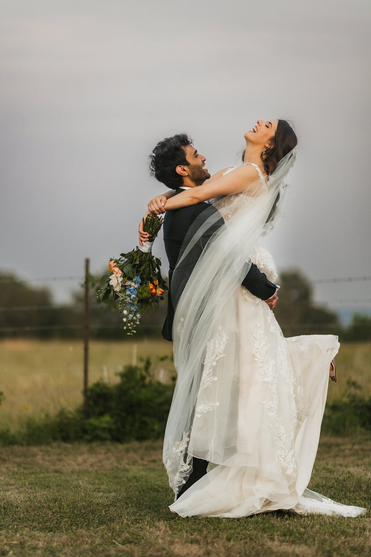 groom-lifts-bride-stonehouse-villa