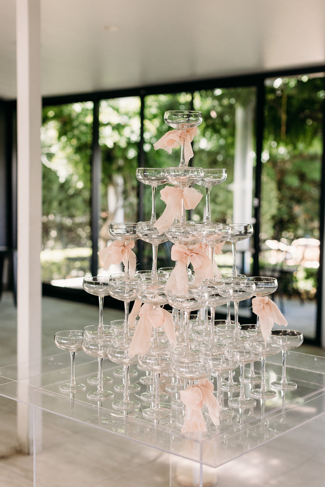 Champagne tower with pink bows