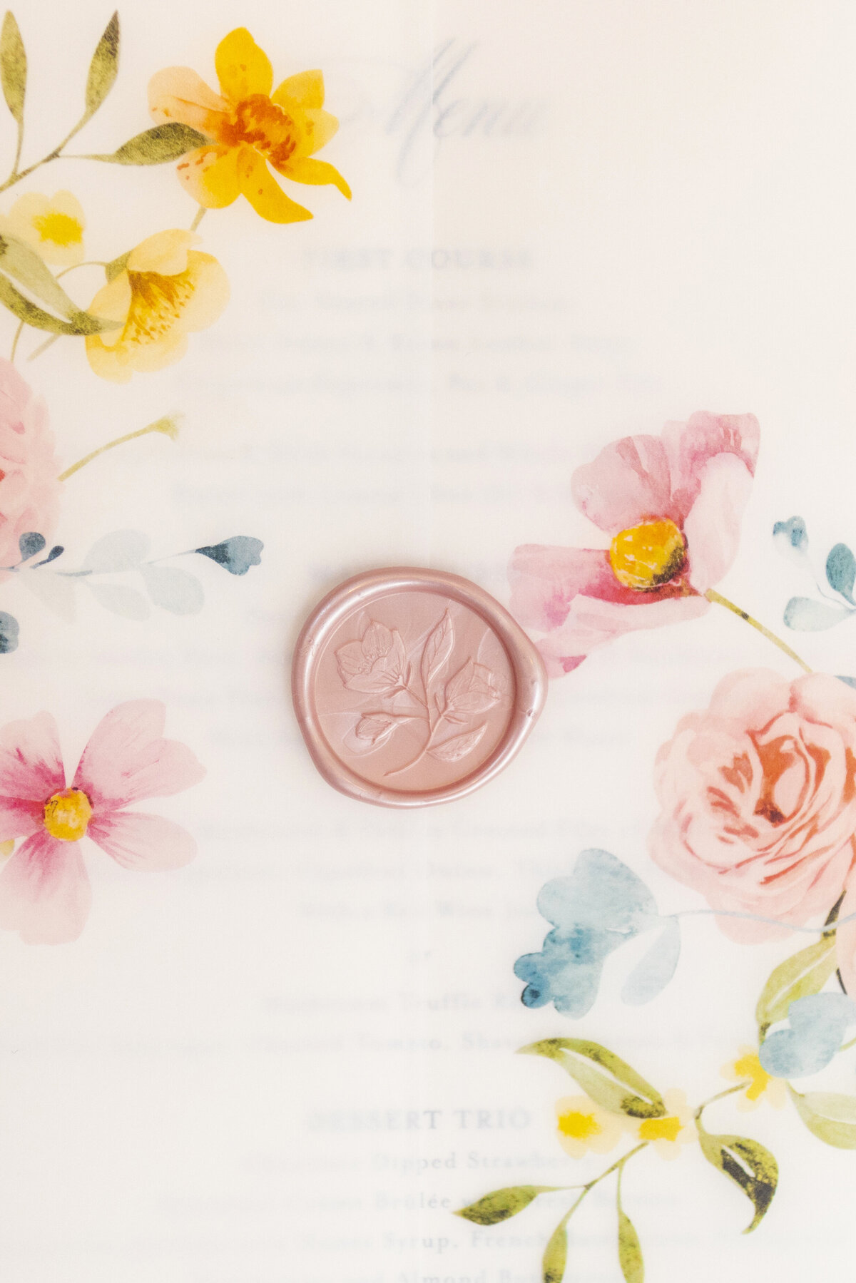 A delicate, floral-themed paper with soft pink, yellow, and blue flowers on the corners. In the center, theres a pink wax seal with a floral imprint. The text is blurred, focusing on the aesthetic details.