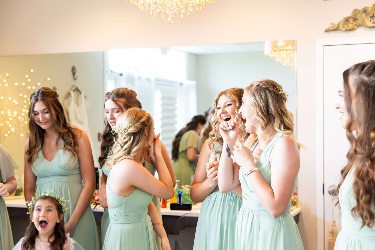 Bridesmaids reaction after seeing bride in dress at  Ruby Cora wedding venue in Clarksville, TB