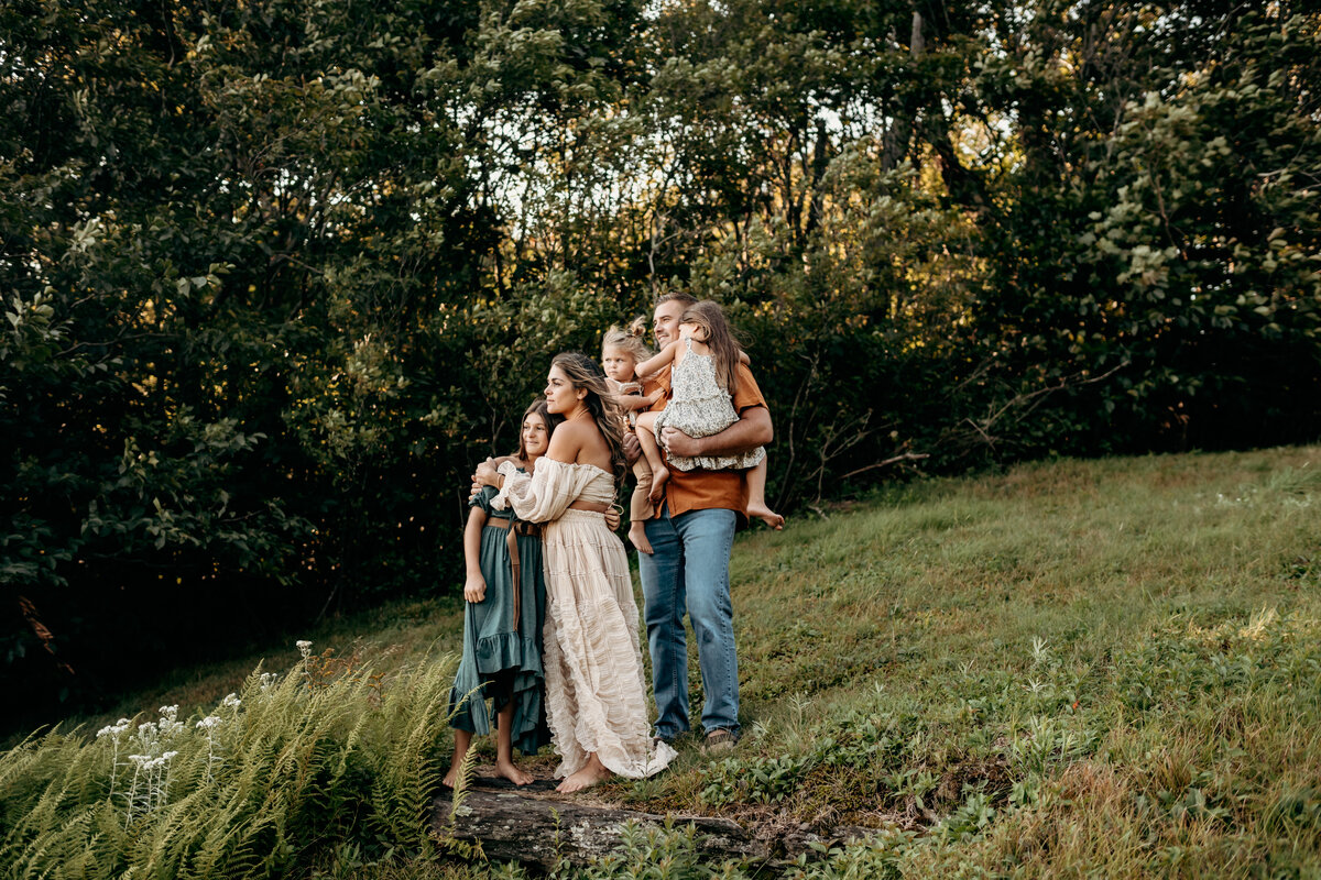 Family hugging 9 month old baby boy at Trexler Nature preseve