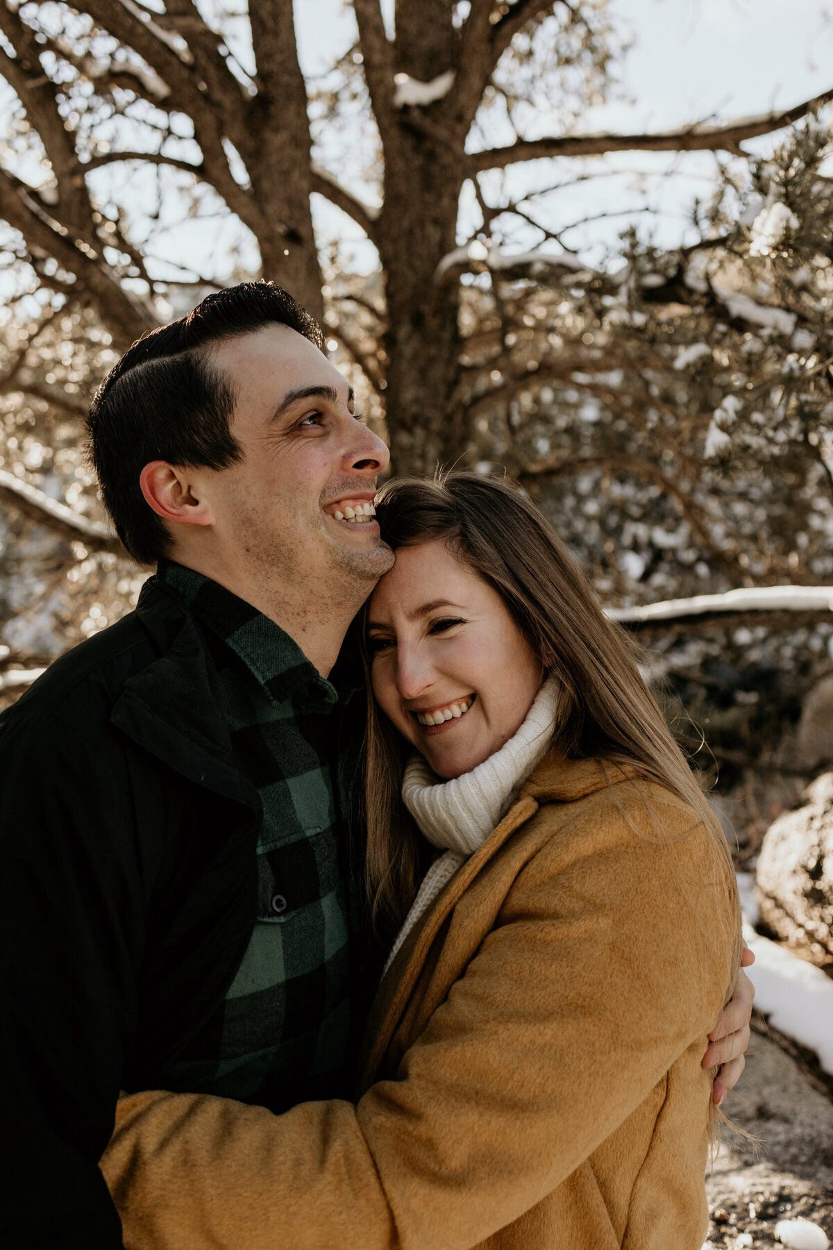 couple holding each other on a snowy mountain