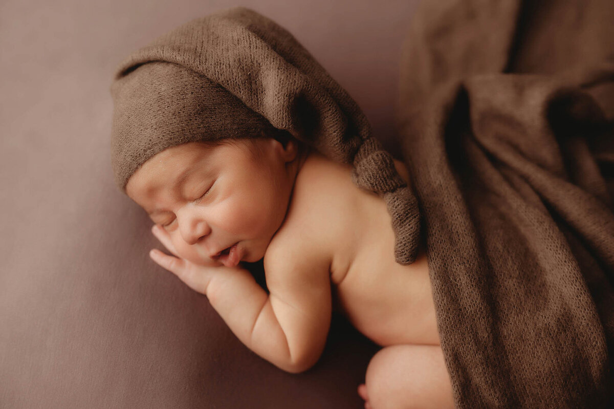 Infant posed for Newborn Photoshoot in Charleston, SC.