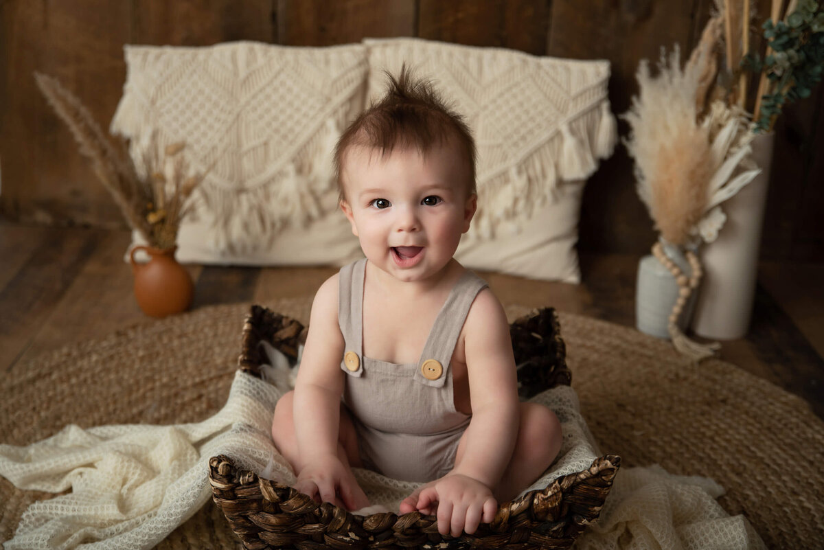 8 month old baby boy sitting in a basket for his kids family photos in Burlington, Ontario