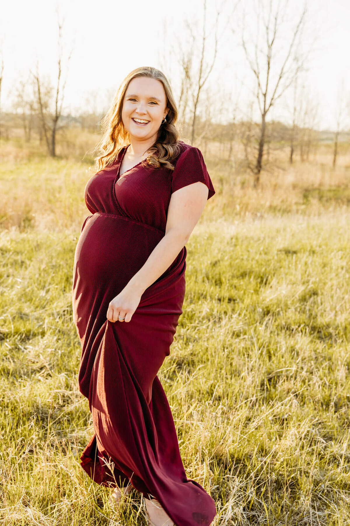 mom to be playing in her dress during her Green Bay maternity session