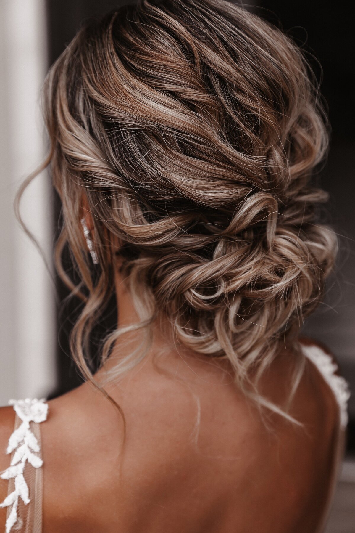 Elopement photography, whimsical bridal updo from behind on curly golden hair