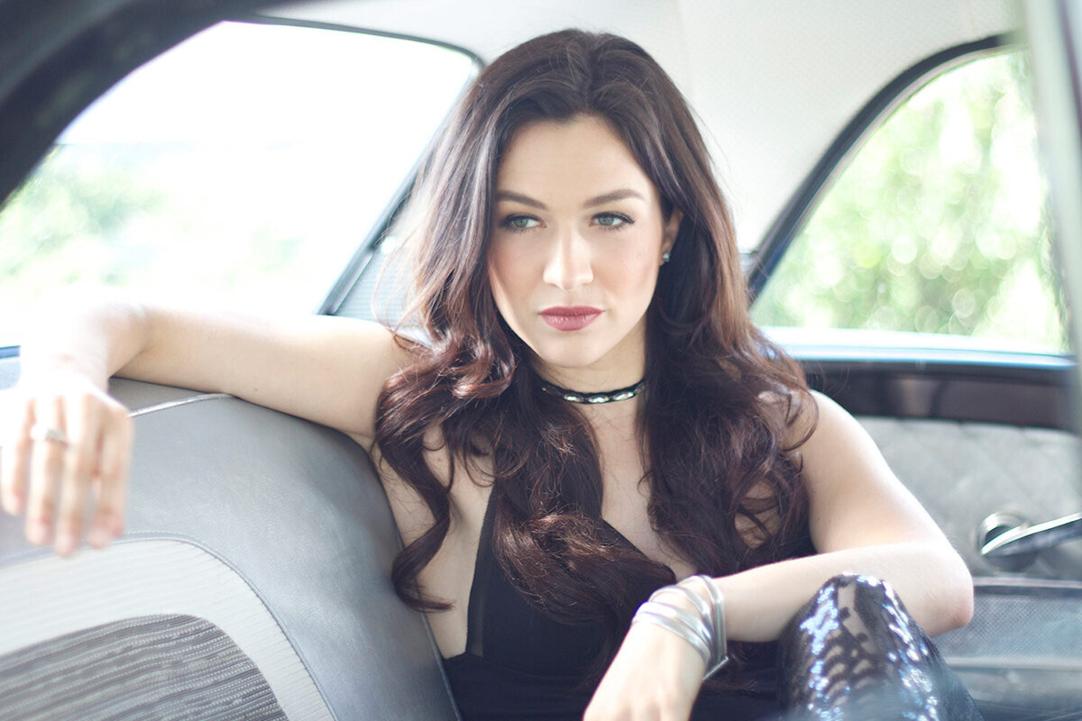 Female Country Music Portrait Kristin Cartin ditting in backseat of vintage car